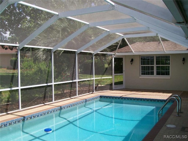 view of swimming pool with a lanai