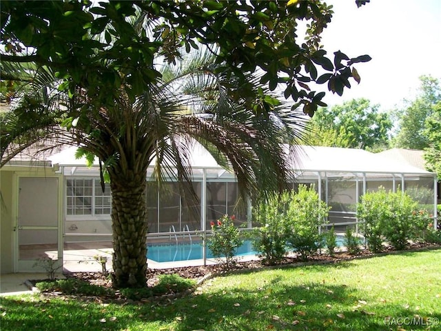 view of yard with glass enclosure