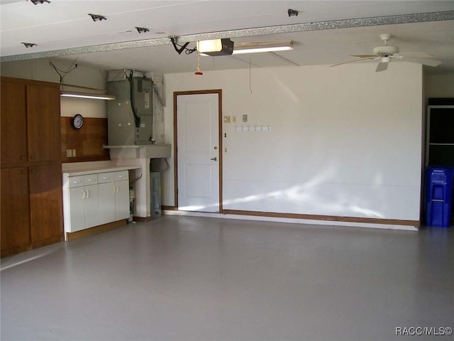 garage featuring ceiling fan, a garage door opener, and heating unit