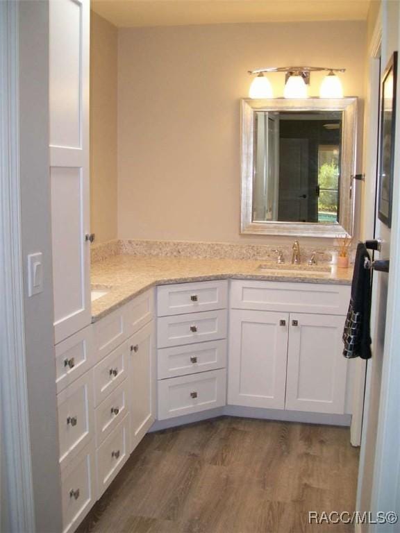 bathroom featuring vanity and hardwood / wood-style floors