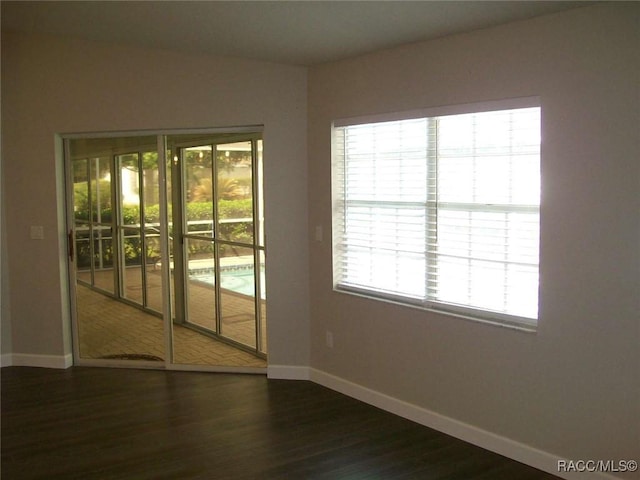 spare room with dark hardwood / wood-style floors