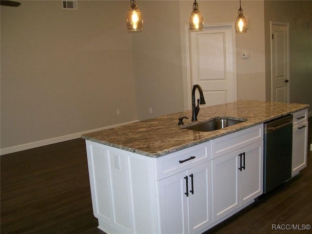 kitchen featuring dishwasher, an island with sink, sink, white cabinets, and light stone countertops