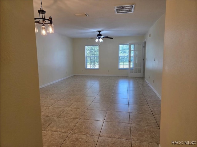 933 N Rembrandt Way, Inverness, FL 34453 - tiled spare room with ceiling fan and a chandelier