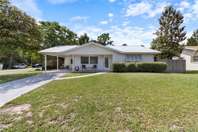 single story home featuring a front lawn and a carport