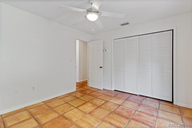 unfurnished bedroom with a closet, ceiling fan, and light tile patterned flooring