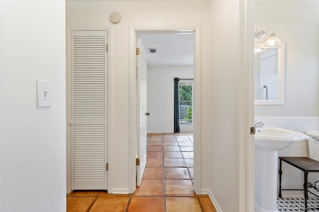 hall with light tile patterned floors