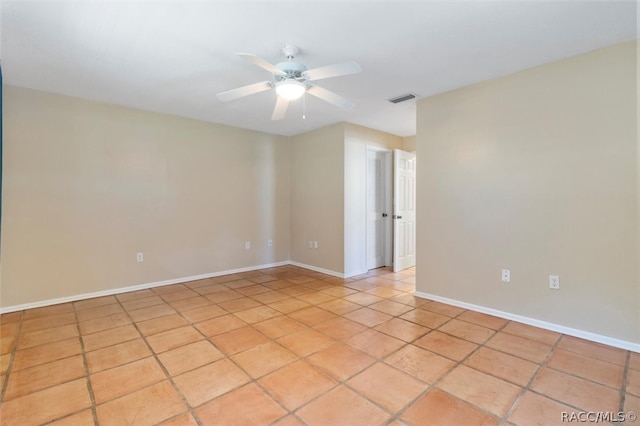 tiled empty room with ceiling fan