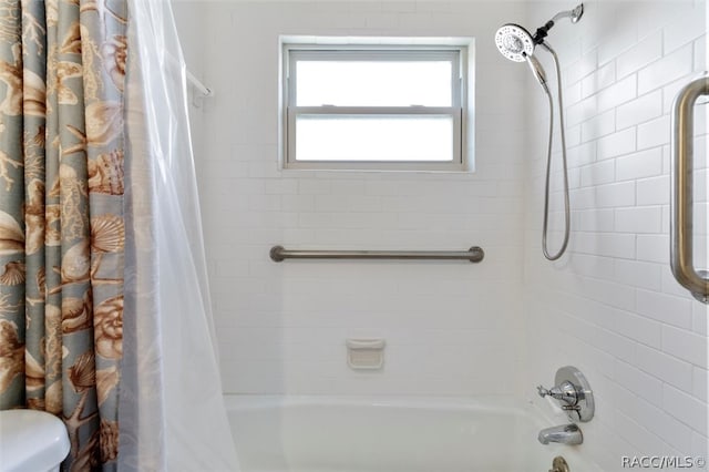 bathroom featuring toilet and shower / bath combo with shower curtain