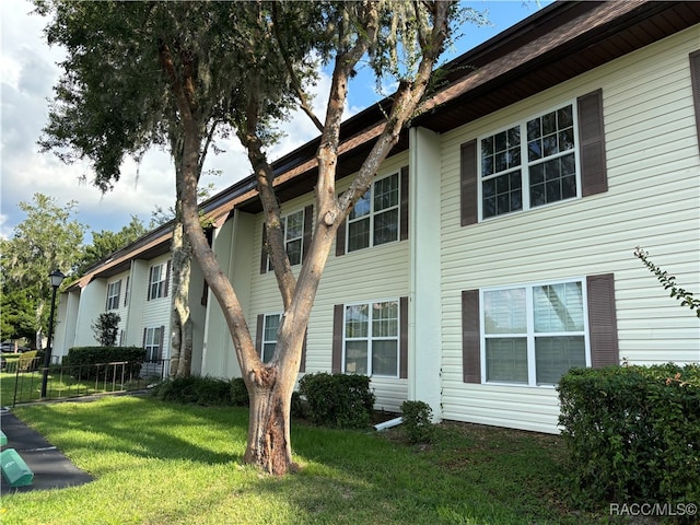 view of side of property with a yard