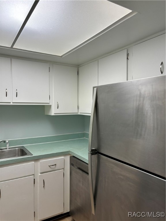 kitchen with white cabinetry, sink, and appliances with stainless steel finishes