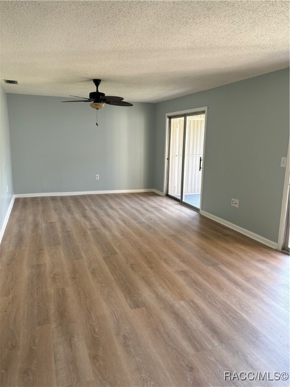 spare room with wood-type flooring, a textured ceiling, and ceiling fan