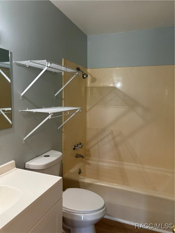 full bathroom featuring hardwood / wood-style floors, vanity, toilet, and bathtub / shower combination