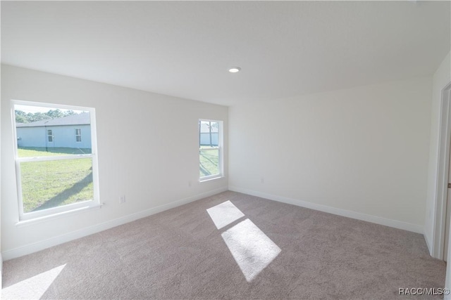 unfurnished room with light carpet