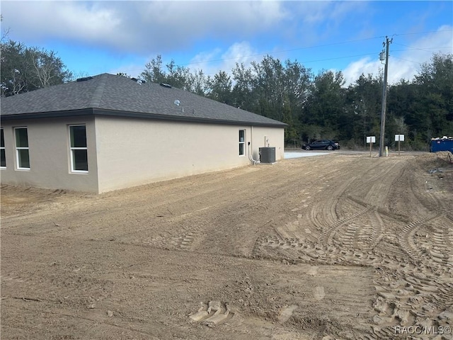 view of side of property featuring central AC unit