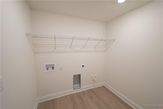 laundry room featuring hookup for a washing machine, hardwood / wood-style floors, and electric dryer hookup