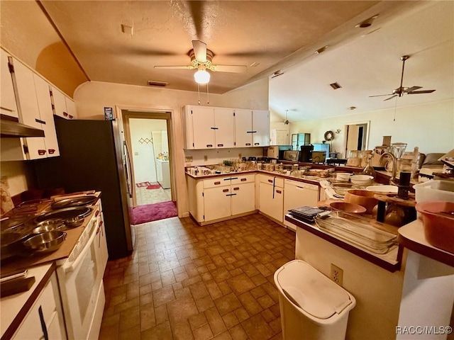 2750 W Mustang Blvd, Beverly Hills, FL 34465 - kitchen featuring ceiling fan, wall oven, white cabinets, brick patterned flooring, and lofted ceiling