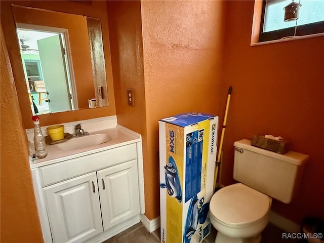 2750 W Mustang Blvd, Beverly Hills, FL 34465 - bathroom featuring vanity, a ceiling fan, a textured wall, and tile patterned floors