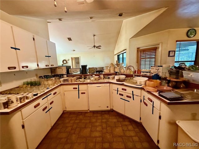 2750 W Mustang Blvd, Beverly Hills, FL 34465 - kitchen with dishwasher, lofted ceiling, ceiling fan, white cabinetry, and brick patterned flooring