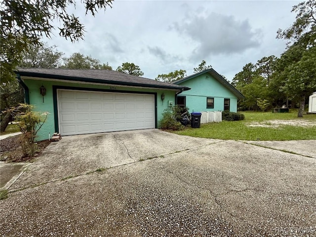 2750 W Mustang Blvd, Beverly Hills, FL 34465 - view of home's exterior featuring concrete driveway, stucco siding, a yard, and an attached garage