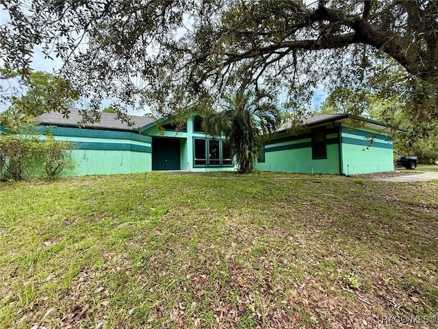 2750 W Mustang Blvd, Beverly Hills, FL 34465 - rear view of house with a yard