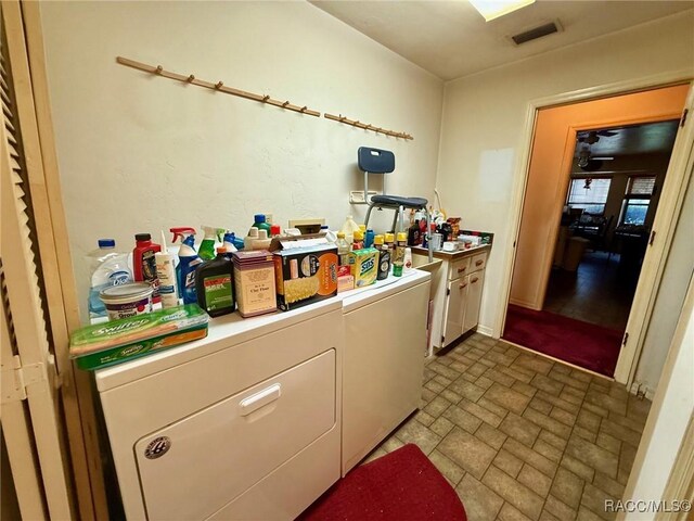 2750 W Mustang Blvd, Beverly Hills, FL 34465 - washroom with washer and dryer, cabinet space, and brick patterned flooring
