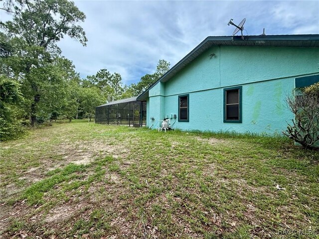 2750 W Mustang Blvd, Beverly Hills, FL 34465 - view of green lawn with a lanai