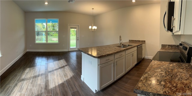 kitchen with white cabinets, hanging light fixtures, sink, and appliances with stainless steel finishes