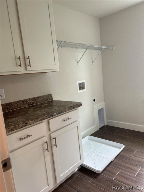 laundry room featuring cabinets, hookup for a washing machine, dark wood-type flooring, and hookup for an electric dryer