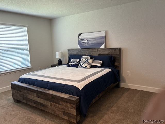 bedroom featuring carpet and a textured ceiling