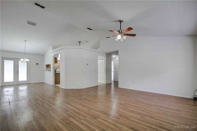 unfurnished living room with french doors, high vaulted ceiling, wood-type flooring, and ceiling fan with notable chandelier