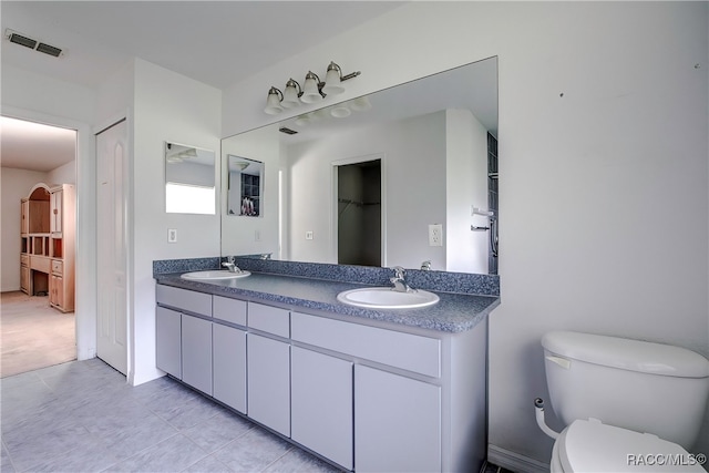 bathroom featuring tile patterned flooring, vanity, and toilet