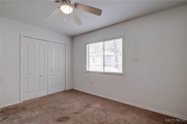 unfurnished bedroom featuring ceiling fan, light carpet, and a closet