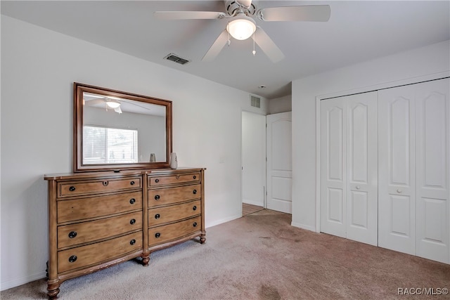 bedroom featuring ceiling fan, a closet, and light carpet