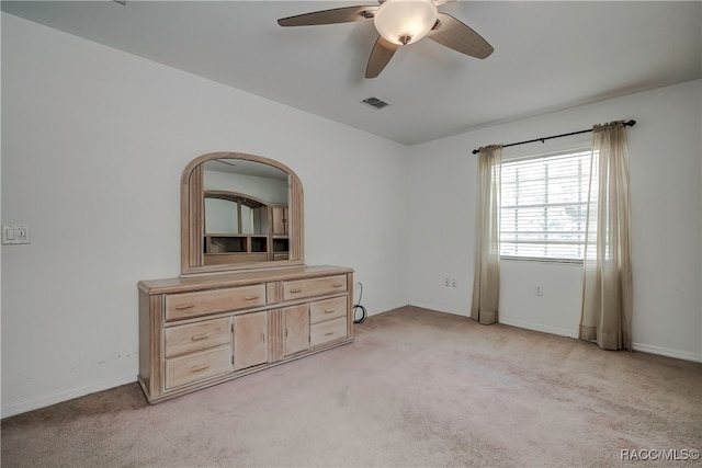 unfurnished bedroom with ceiling fan and light carpet