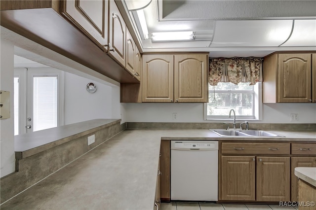 kitchen with dishwasher, light tile patterned flooring, and sink