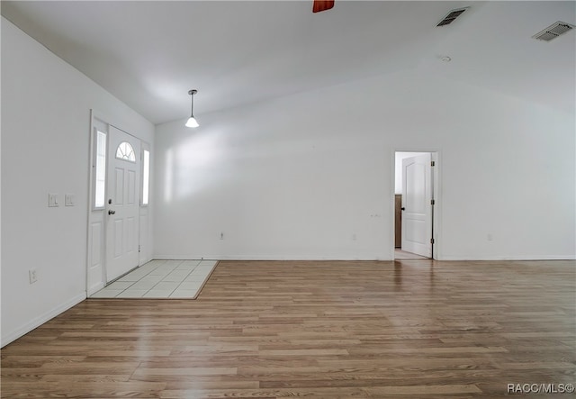 entryway featuring light wood-type flooring and vaulted ceiling