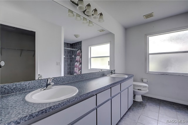 bathroom featuring curtained shower, tile patterned flooring, vanity, and toilet