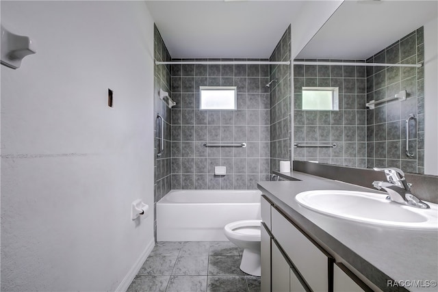 full bathroom featuring toilet, vanity, and tiled shower / bath combo