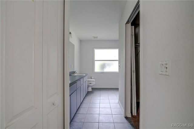 bathroom featuring tile patterned flooring, vanity, and toilet