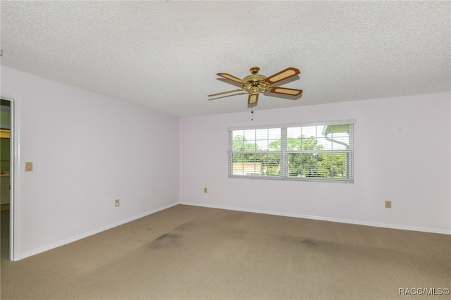 carpeted empty room with a textured ceiling and ceiling fan