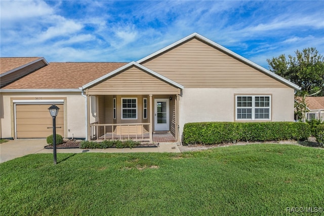 ranch-style home with a front lawn, covered porch, and a garage