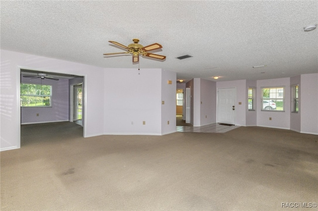 empty room with carpet and a textured ceiling