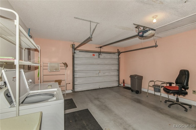 garage with washing machine and clothes dryer and a garage door opener