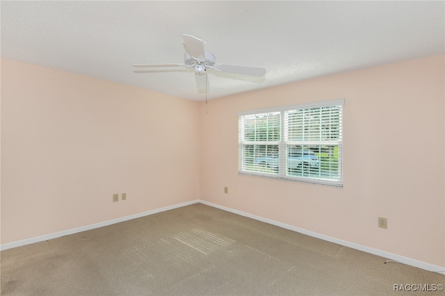 carpeted empty room featuring a textured ceiling and ceiling fan