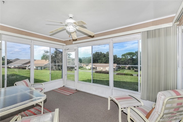 sunroom / solarium with ceiling fan and plenty of natural light