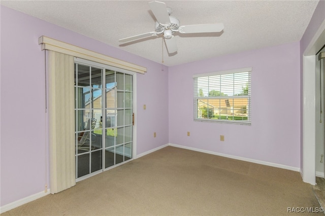 spare room featuring carpet, a textured ceiling, and ceiling fan