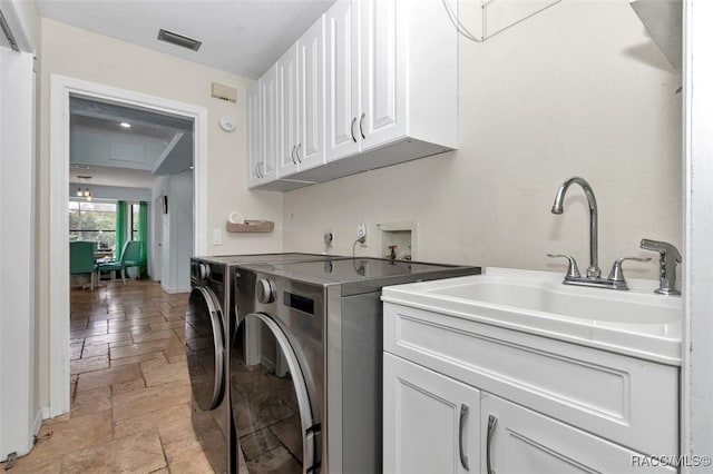 391 E Falconry Ct, Hernando, FL 34442 - laundry area with stone tile floors, cabinet space, and washer and dryer