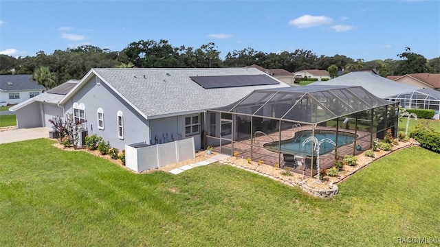 391 E Falconry Ct, Hernando, FL 34442 - back of property featuring a hot tub, a shingled roof, and a yard