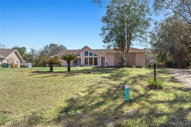 ranch-style home with a front yard