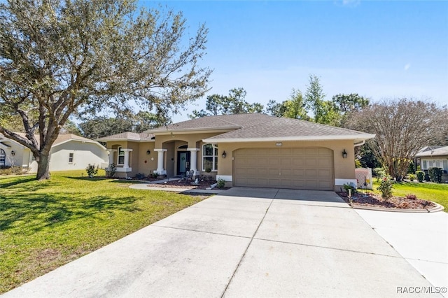 single story home featuring a front yard, driveway, an attached garage, and stucco siding